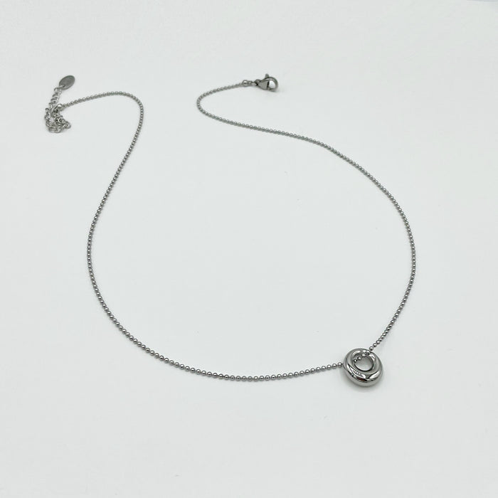 Silver necklace with dainty small circular pendant bead