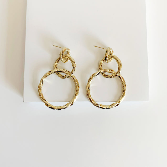 Gold twisted circle linked drop earrings 