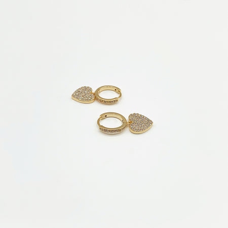 Small gold hoop earrings with drop heart charm paved in diamanté’s 