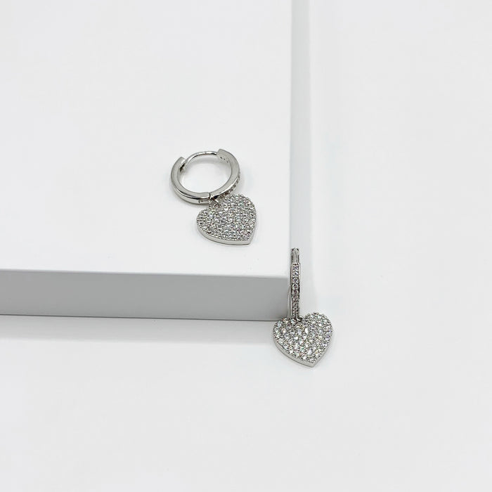 Small silver hoop earrings with drop heart charm, paved with rhinestones 