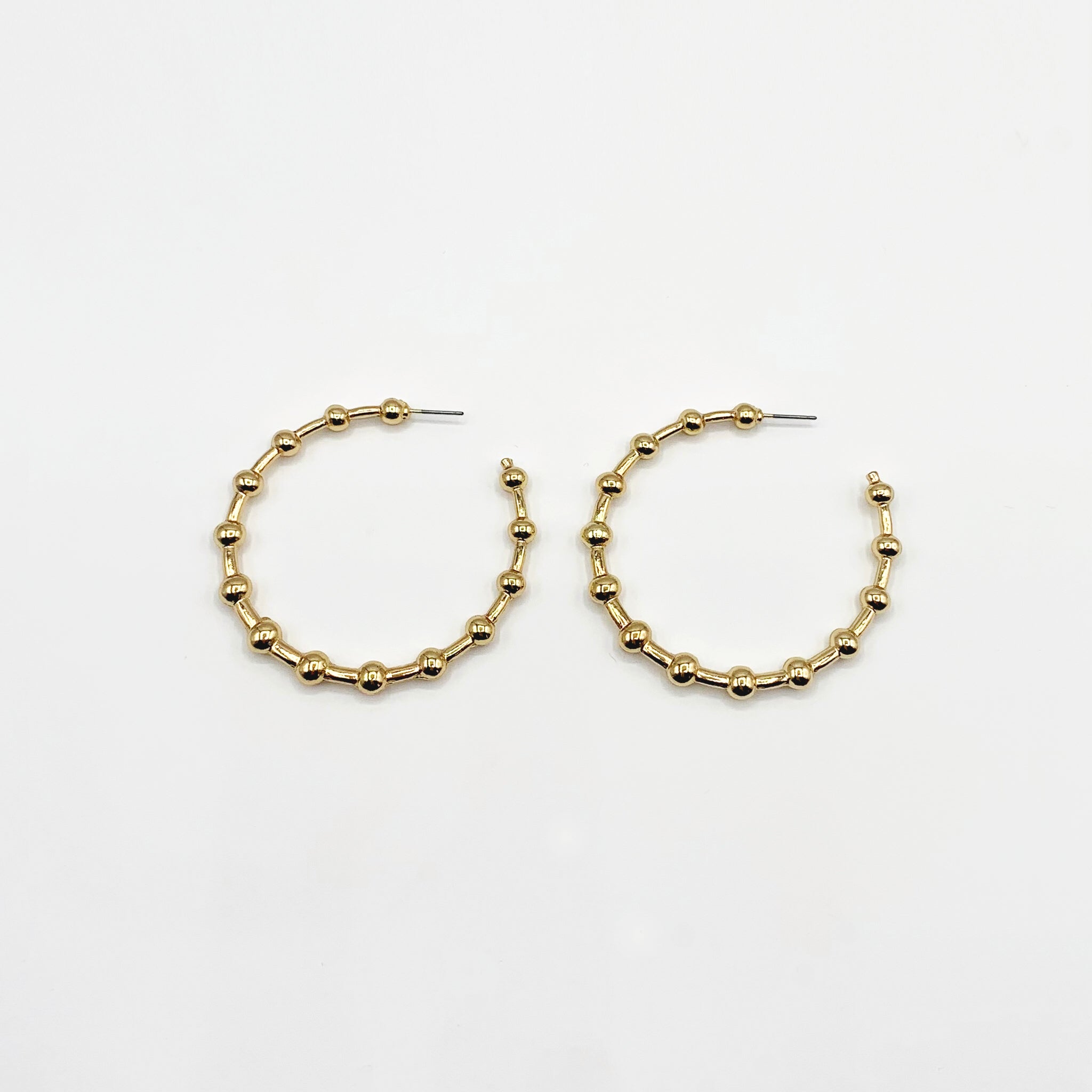 Large gold hoop earrings with ball detailing