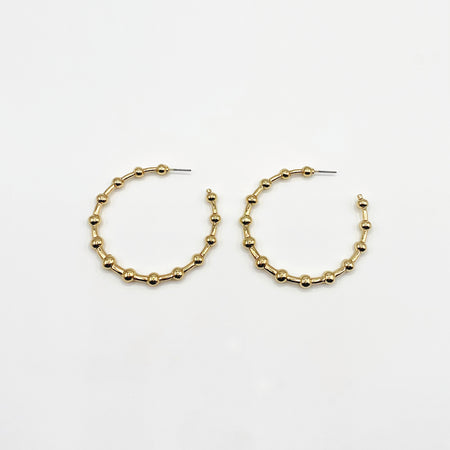 Large gold hoop earrings with ball detailing