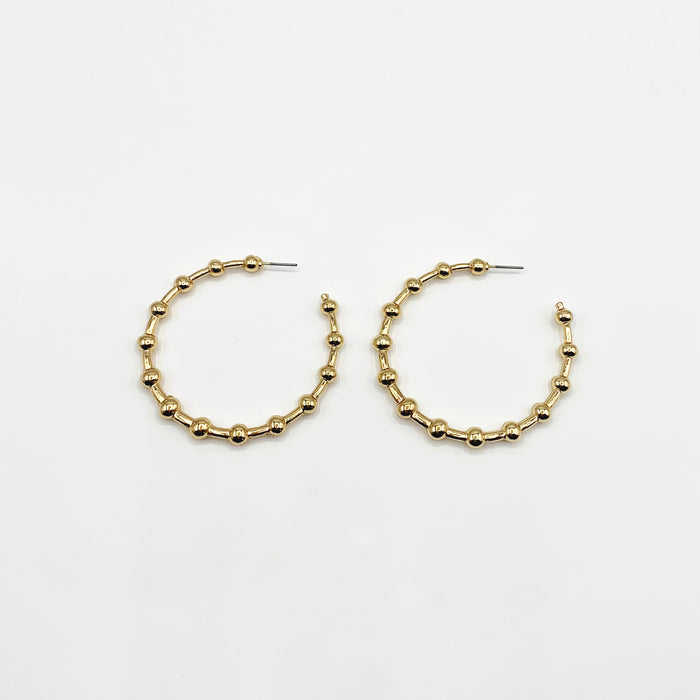 Large gold hoop earrings with ball detailing