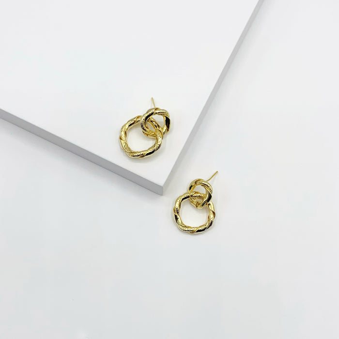 Small gold entwined circle drop earrings with texture